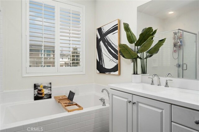 bathroom featuring vanity, a garden tub, and a stall shower