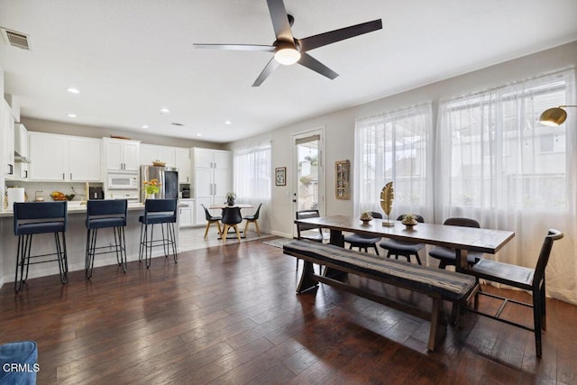 dining space featuring a ceiling fan, dark wood-style floors, and visible vents