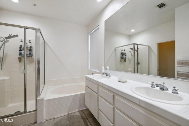 full bathroom featuring a sink, a stall shower, a bath, and visible vents
