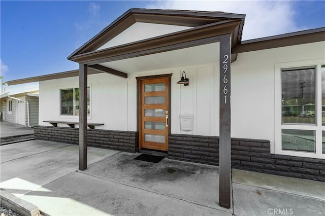 property entrance featuring a patio area