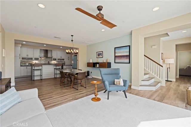 28292 N Via Sonata Dr, Valencia, CA 91354 - living room with ceiling fan, a chandelier, light wood-type flooring, recessed lighting, and stairs