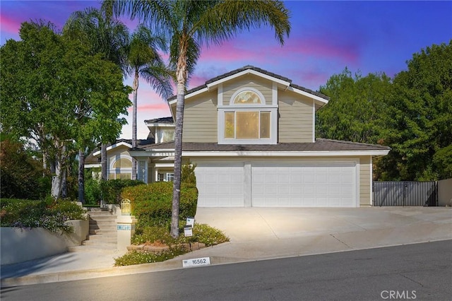 16562 Orangewind Ln, Riverside, CA 92503 - traditional-style house featuring an attached garage and concrete driveway