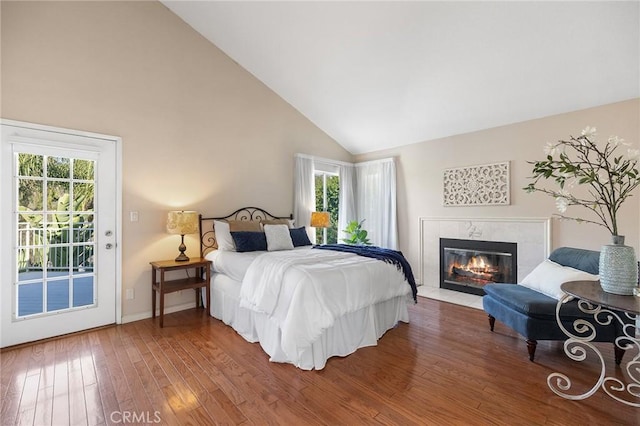 16562 Orangewind Ln, Riverside, CA 92503 - bedroom featuring access to exterior, wood finished floors, a premium fireplace, multiple windows, and high vaulted ceiling