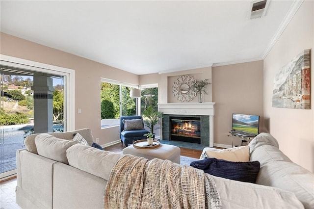 16562 Orangewind Ln, Riverside, CA 92503 - living area featuring wood finished floors, a tiled fireplace, baseboards, and crown molding