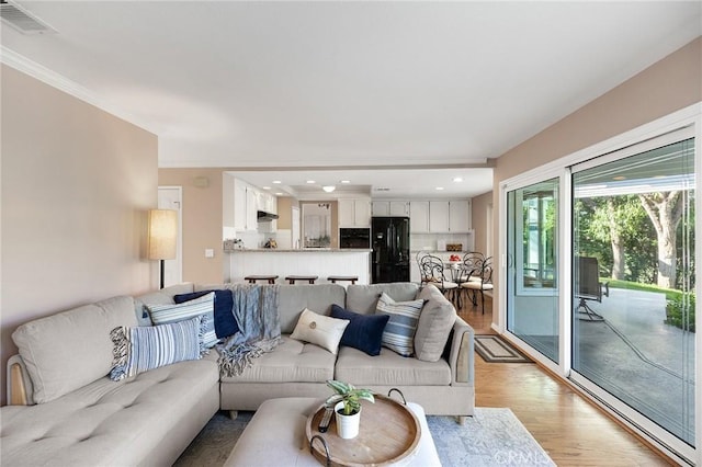 16562 Orangewind Ln, Riverside, CA 92503 - living room with crown molding, light wood-style floors, and recessed lighting