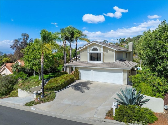 16562 Orangewind Ln, Riverside, CA 92503 - traditional-style house featuring an attached garage, driveway, and a chimney