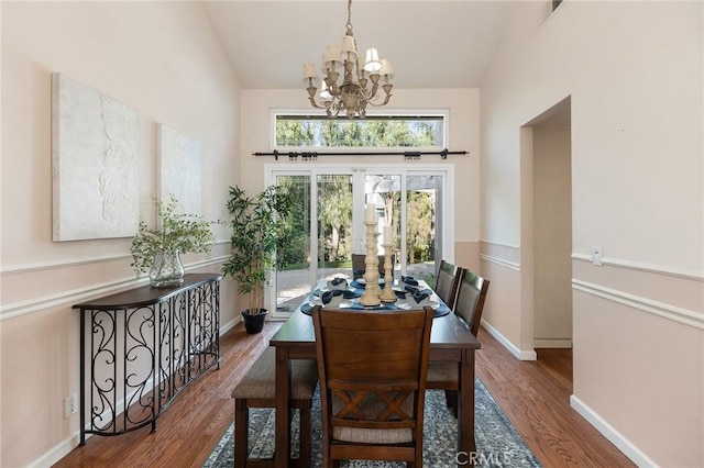 16562 Orangewind Ln, Riverside, CA 92503 - dining room featuring a chandelier, wood finished floors, vaulted ceiling, and baseboards