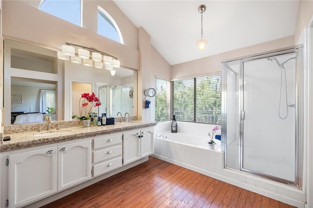16562 Orangewind Ln, Riverside, CA 92503 - ensuite bathroom featuring lofted ceiling, a bath, hardwood / wood-style floors, double vanity, and a shower stall