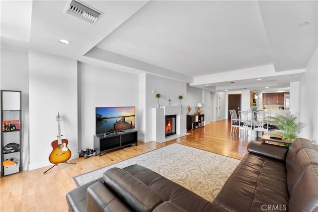 920 Granite Dr Unit 502, Pasadena, CA 91101 - living room with a glass covered fireplace, baseboards, wood finished floors, and visible vents