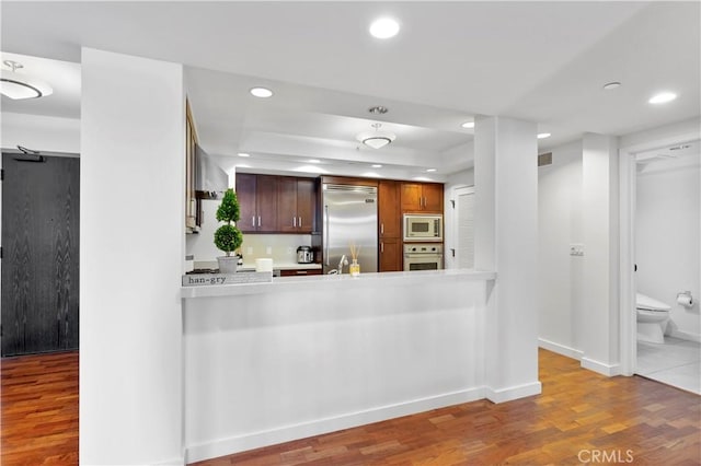 920 Granite Dr Unit 502, Pasadena, CA 91101 - kitchen featuring built in appliances, wood finished floors, recessed lighting, light countertops, and a tray ceiling