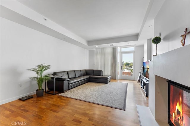920 Granite Dr Unit 502, Pasadena, CA 91101 - living room with baseboards, a lit fireplace, and light wood-type flooring