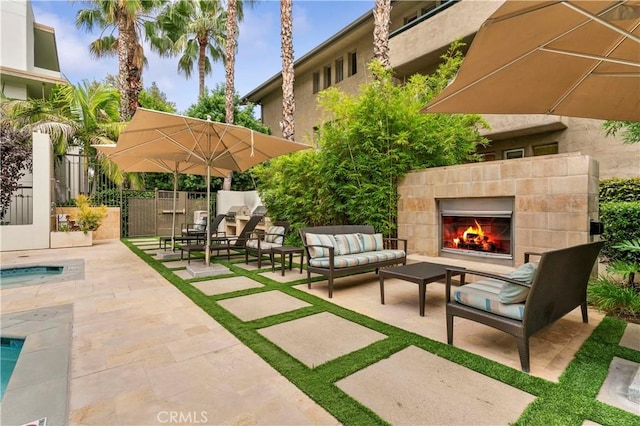 920 Granite Dr Unit 502, Pasadena, CA 91101 - view of patio / terrace with fence and an outdoor living space with a fireplace