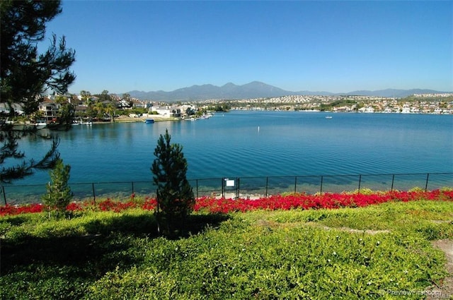 view of water feature featuring fence and a mountain view