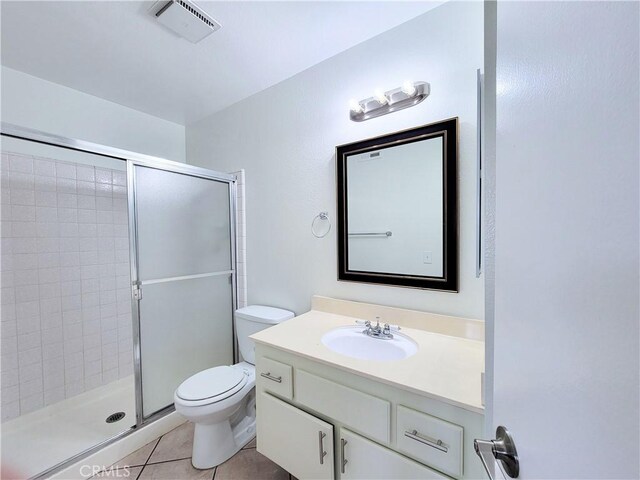 full bathroom featuring visible vents, tile patterned flooring, a stall shower, vanity, and toilet