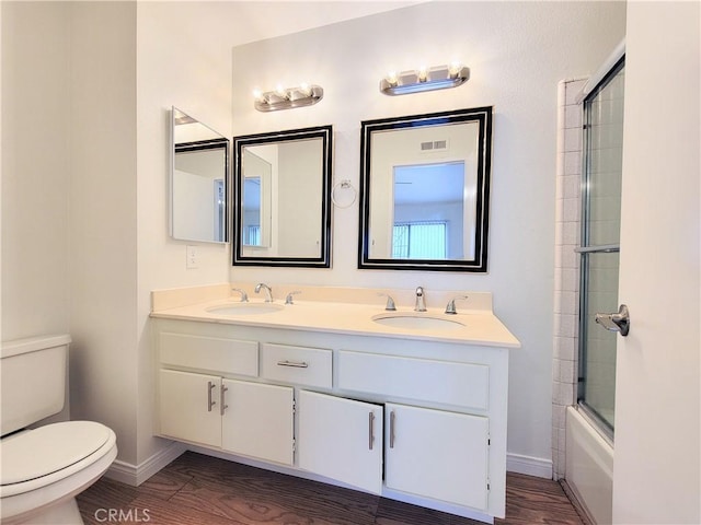 bathroom featuring a sink, baseboards, toilet, and visible vents