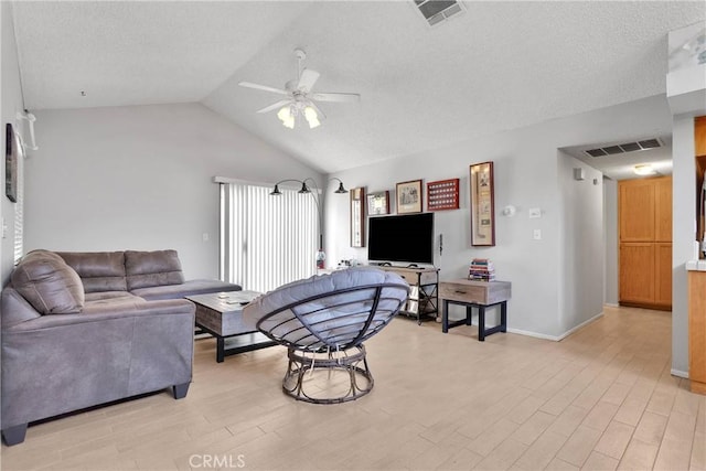 living area featuring a ceiling fan, visible vents, light wood-style flooring, and lofted ceiling