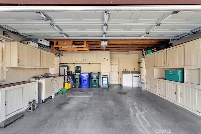 garage featuring separate washer and dryer and a garage door opener