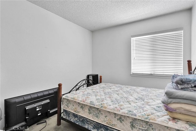 bedroom featuring carpet floors and a textured ceiling