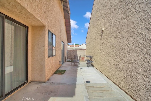 view of home's exterior featuring fence, a patio area, and stucco siding