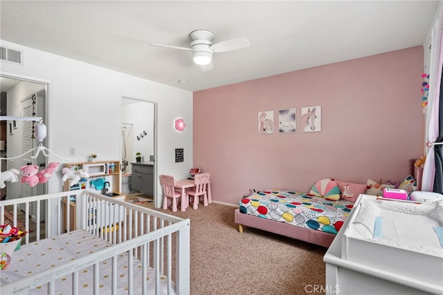 carpeted bedroom featuring visible vents and a ceiling fan