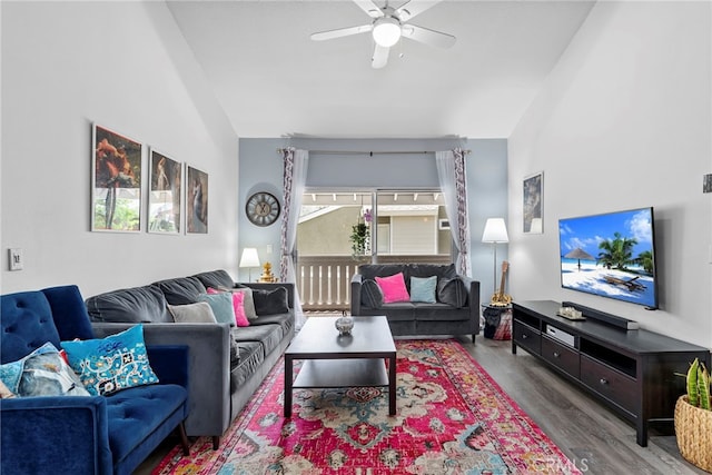 living room featuring wood finished floors, a ceiling fan, and lofted ceiling