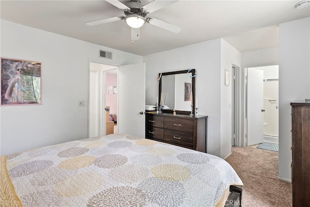 bedroom with connected bathroom, ceiling fan, visible vents, and carpet
