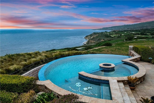 view of swimming pool featuring a water view and an outdoor fire pit