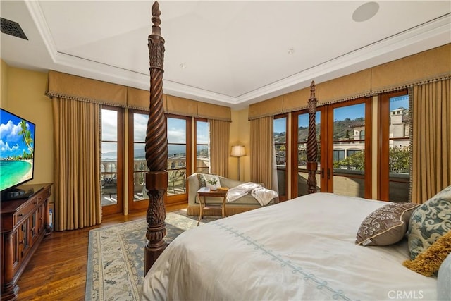 bedroom with visible vents, access to exterior, and wood finished floors