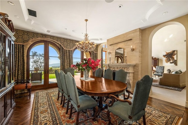dining room featuring an inviting chandelier, arched walkways, french doors, and visible vents