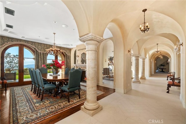 interior space featuring arched walkways, ornate columns, and a notable chandelier