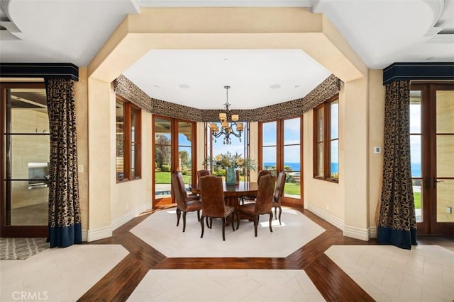 dining area with baseboards and a chandelier