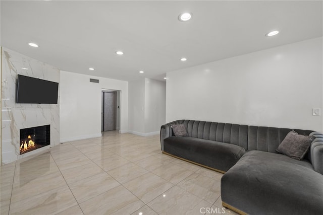 living room featuring visible vents, a fireplace, baseboards, recessed lighting, and light tile patterned floors