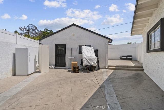 exterior space with a patio, stucco siding, and fence