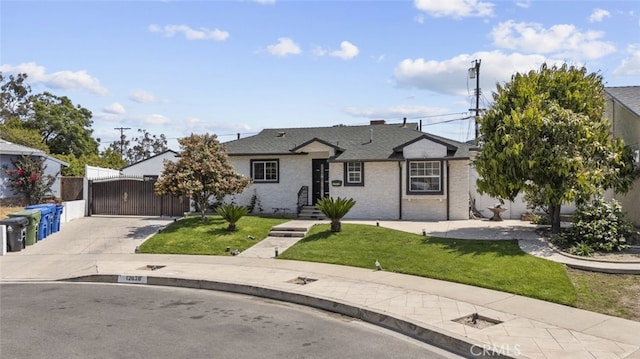 bungalow featuring fence, driveway, a gate, and a front yard