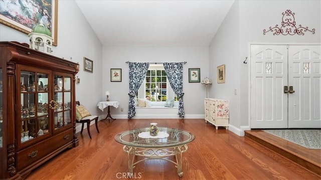 entrance foyer with baseboards and wood finished floors