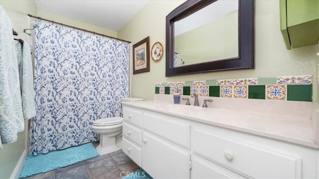 bathroom featuring toilet, a shower with curtain, and vanity