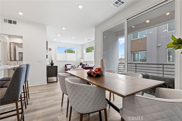dining area featuring recessed lighting, light wood finished floors, and visible vents