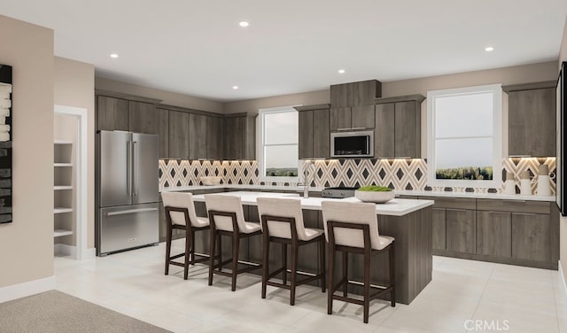 kitchen featuring a center island, light countertops, a kitchen breakfast bar, and stainless steel appliances