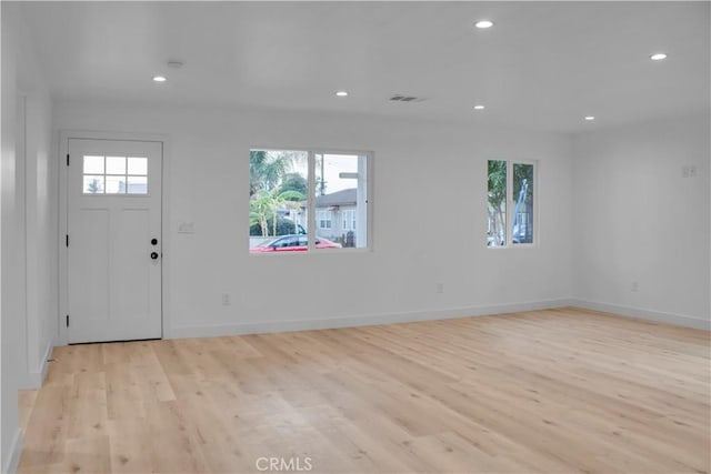 foyer entrance featuring recessed lighting, baseboards, light wood-type flooring, and visible vents