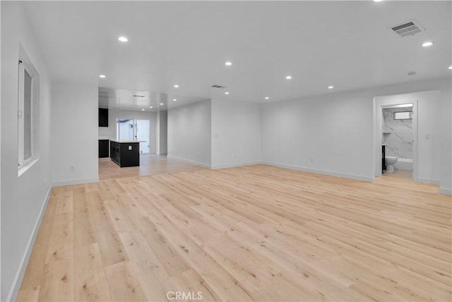 unfurnished living room with recessed lighting, baseboards, visible vents, and light wood finished floors