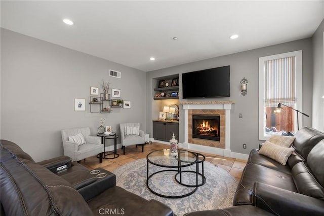 9 Woodlake Dr, Buena Park, CA 90621 - living room featuring built in shelves, a tiled fireplace, recessed lighting, light tile patterned floors, and visible vents