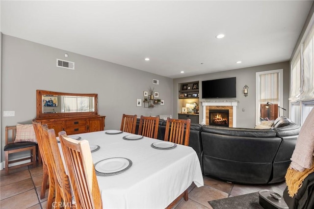 9 Woodlake Dr, Buena Park, CA 90621 - dining space with plenty of natural light, a lit fireplace, visible vents, recessed lighting, and light tile patterned flooring