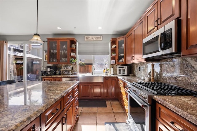 9 Woodlake Dr, Buena Park, CA 90621 - kitchen with a sink, stainless steel appliances, light tile patterned floors, tasteful backsplash, and pendant lighting