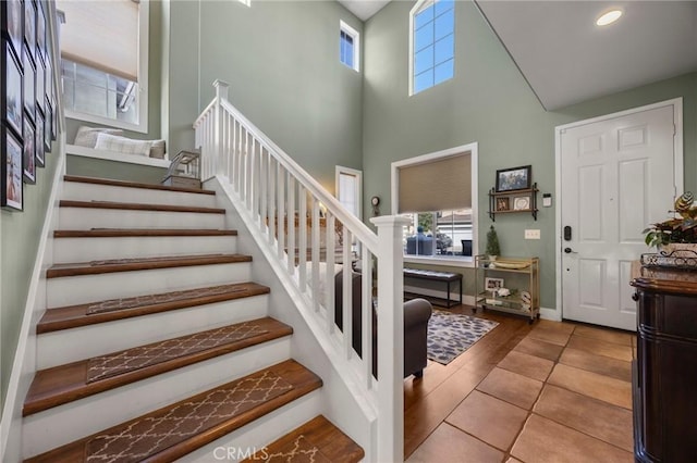 9 Woodlake Dr, Buena Park, CA 90621 - foyer entrance with a healthy amount of sunlight, tile patterned flooring, a high ceiling, and stairs