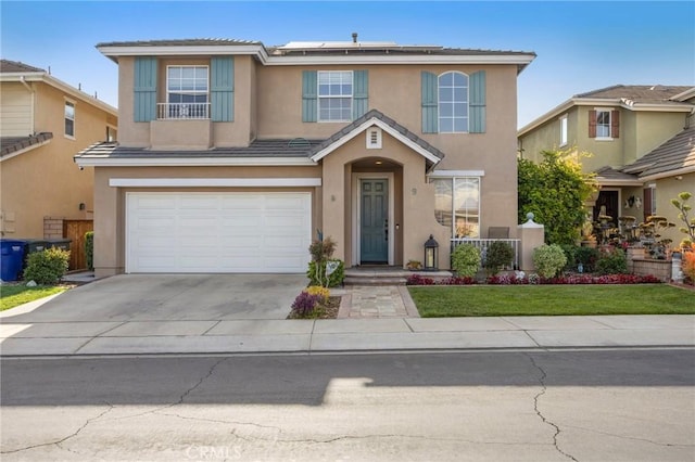 9 Woodlake Dr, Buena Park, CA 90621 - traditional home featuring a garage, driveway, solar panels, and stucco siding
