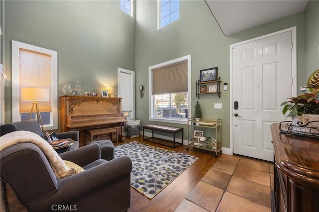 9 Woodlake Dr, Buena Park, CA 90621 - living area featuring baseboards, a towering ceiling, and wood finished floors