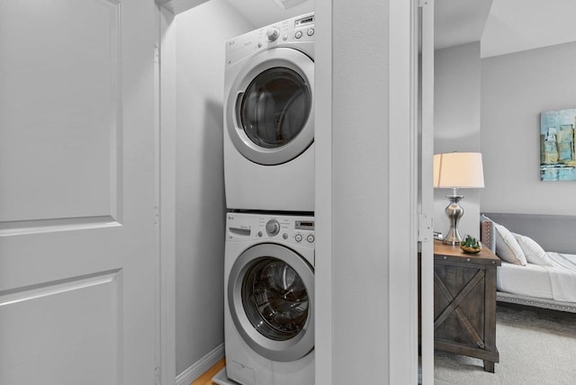 laundry area featuring laundry area and stacked washer and clothes dryer