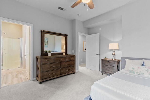 bedroom featuring baseboards, light colored carpet, connected bathroom, and visible vents