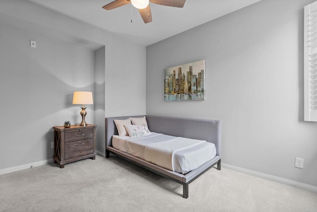 carpeted bedroom featuring a ceiling fan and baseboards