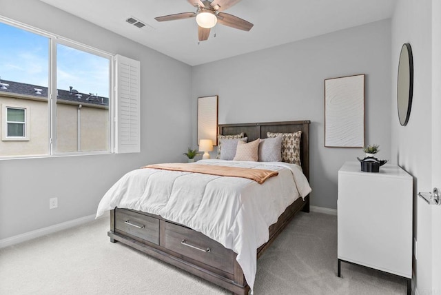 carpeted bedroom with a ceiling fan, baseboards, and visible vents